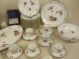 many plates and cups and saucers on the table