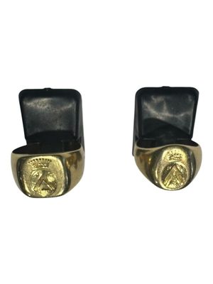 pair of gold plated and black leather cuff earrings with a lion head