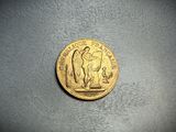 an image of a gold coin with a statue on it