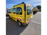 the yellow van is parked in a parking lot with other vehicles