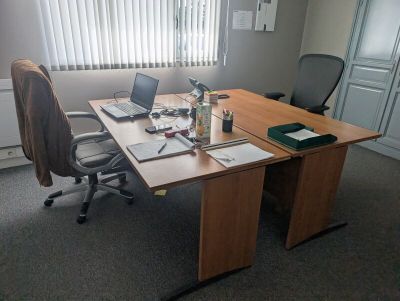 a desk with a laptop and a laptop computer on it