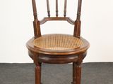 an image of a wooden chair with a cane back and cane seat