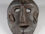 an image of a wooden mask on a white surface