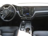 the interior of a car with a steering wheel, dashboard, and dashboard controls