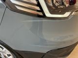 a close up of a car ' s headlight on display in a showroom