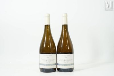 two bottles of wine sitting next to each other on a white surface