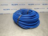 a blue hose on a table in front of a wall