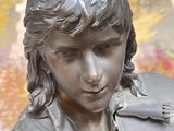 a statue of a young boy holding a violin