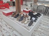 many pairs of shoes on display in a room