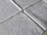 a white table cloth with a monogramed design on it