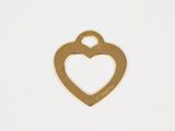 a close up of a heart shaped metal tag on a white surface