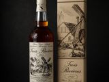 the bottle is next to a cardboard box with a drawing of a windmill