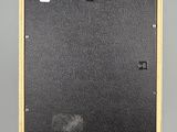 a black and gold picture frame on a gray background
