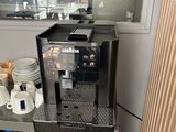 a coffee machine sitting on a shelf in a kitchen