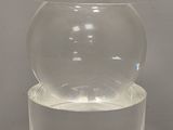 a clear container with water in it sitting on a table