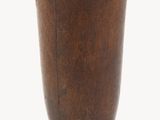 a small wooden vase with a metal base on a white background