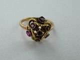 a close up of a gold ring with purple stones on it