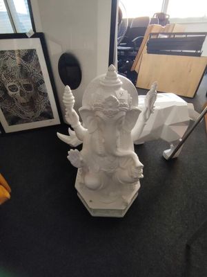 a statue of a person holding a knife in a room