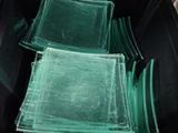 a lot of green bags in a black container