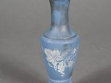a small blue vase with a white design on it