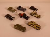 several toy cars are arranged in a circle on a white surface