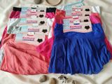 three pairs of underwear are laid out on a bed next to a teddy bear