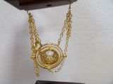 a clock that has a gold chain around it
