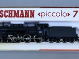 a black train on display in a white box