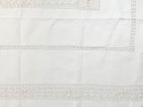 embroidered tablecloth with a cross stitch design on a white background