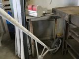 a wheelbarrow leaning against a wall in a garage