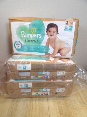 several boxes of diapers sitting on top of a wooden table