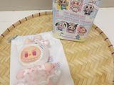 a small stuffed animal sitting on a table next to a box