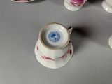 several cups and saucers are sitting on a table with a plate