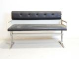 a black and white bench in a room with a white wall