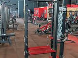 a gym with a lot of machines in the room