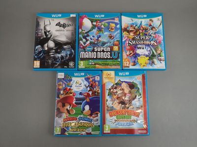 four nintendo wii games are sitting on top of a table