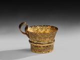 an image of a gold cup sitting on top of a table