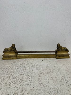 antique brass figurine of a lion and a lioness on a bench