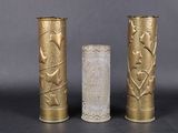 trois vases en or posés les uns à côté des autres sur une table