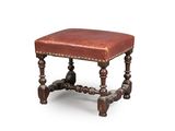 an old wooden stool with a leather seat on a white background