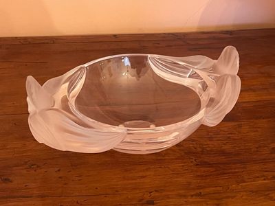 a glass bowl sitting on a wooden table