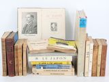 several books are stacked on top of each other on a table