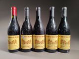 four bottles of wine are lined up on a table