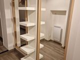 a large mirror in the corner of a room with shelves