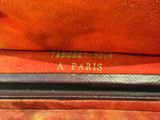 the inside of a red purse with a gold logo on it