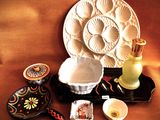 a plate, bowl, candle, and other items on a table