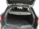 the back of a car with its trunk open and the back seats folded down