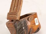 a small wooden object that is sitting on a table
