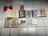 a lot of books on the floor with stamps on them