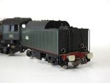 a toy train on a white surface with a white background